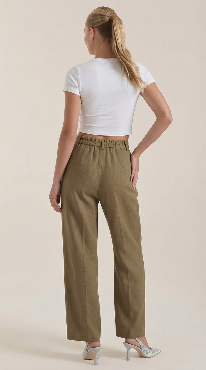 Female model showcasing elegant pants with straight posture plain background, back view