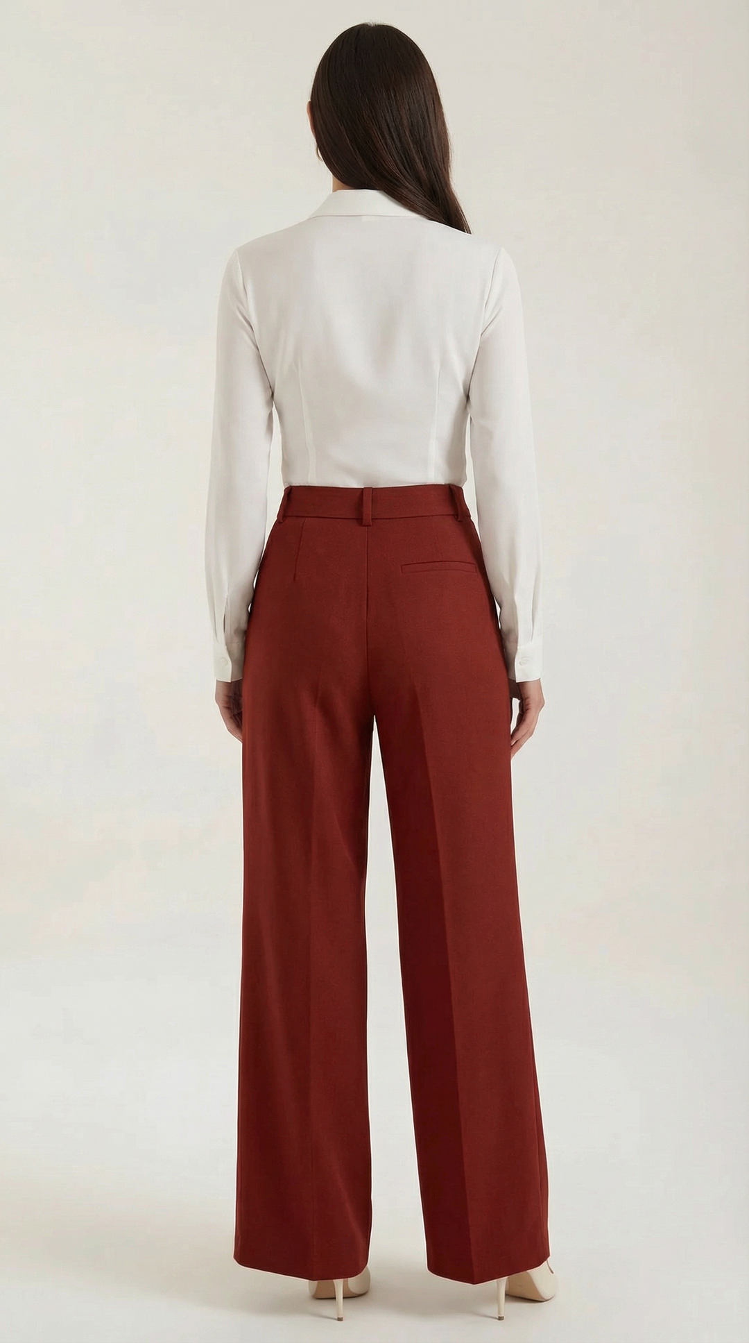 Female model fashion pose wide-leg trousers plain background minimal, back view