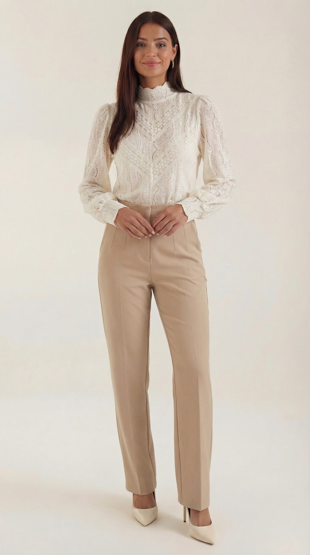 Woman wearing textured blouse front view on plain background