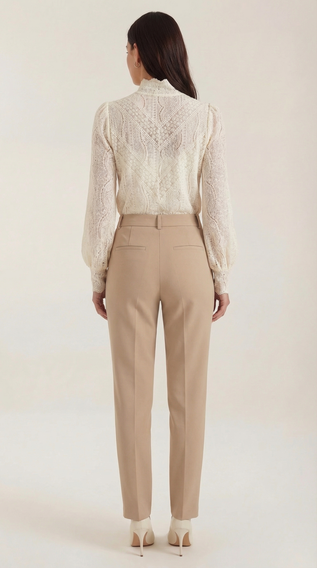 Female model full shot back view, textured blouse plain background
