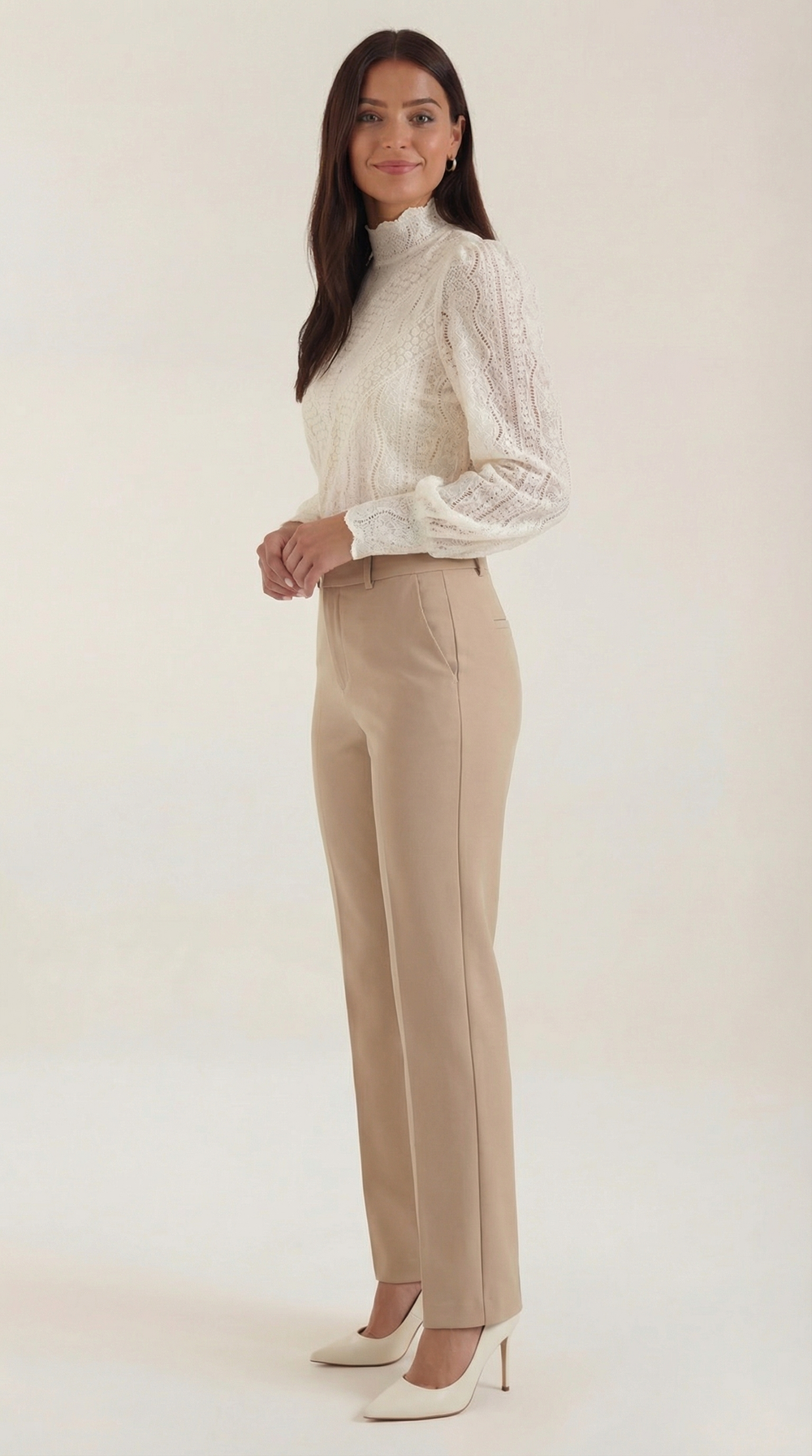Female model side angle wearing elegant textured blouse plain background