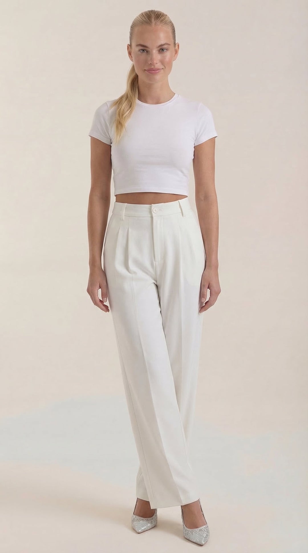 Woman wearing office trousers, front angle, plain background.