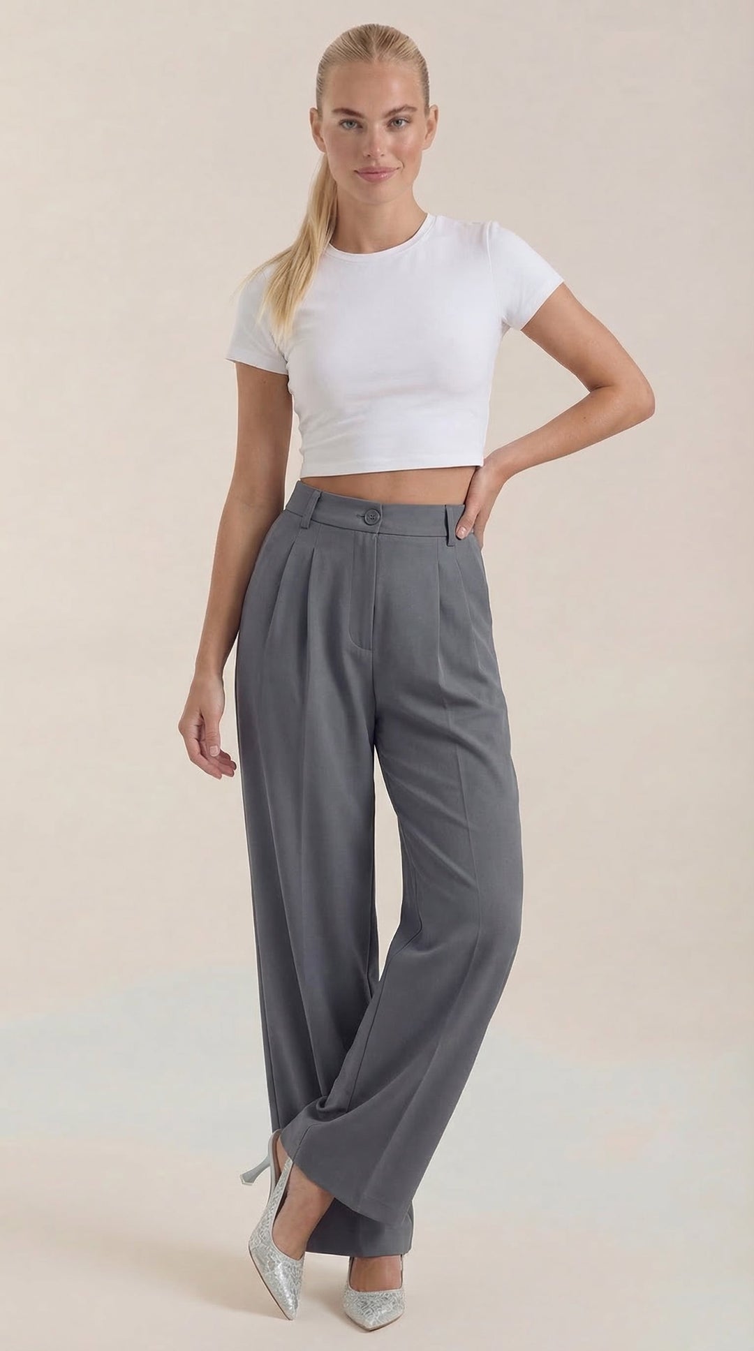 Woman showing full-length wide-leg pants on a plain background.