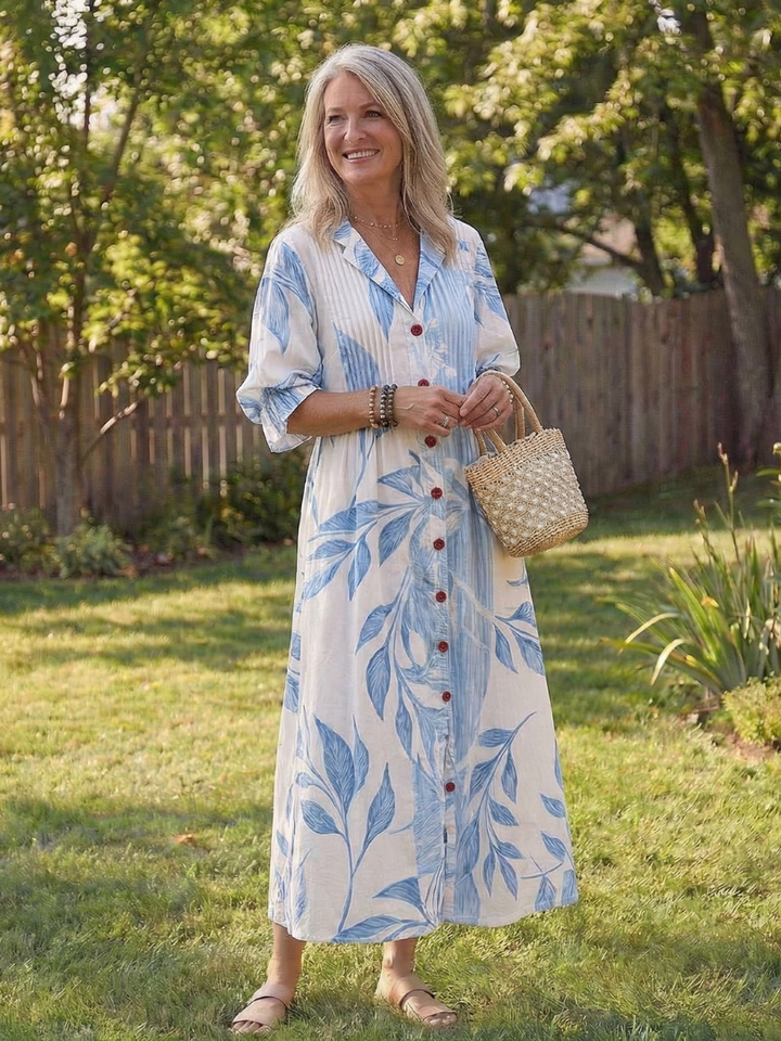Woman wearing a botanical print maxi dress with relaxed silhouette against a nature background.
