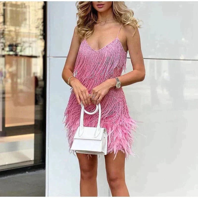 Female model wearing a sequin party dress with a simple plain background.