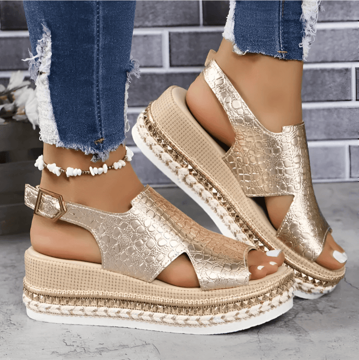 Pair of open-toe sandals arranged neatly on plain background.