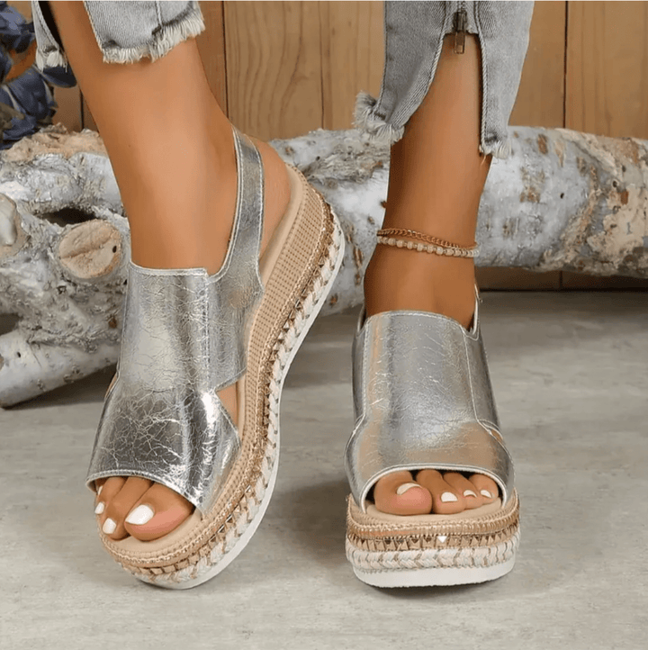 Front-facing image of women’s sandal with secure ankle strap.