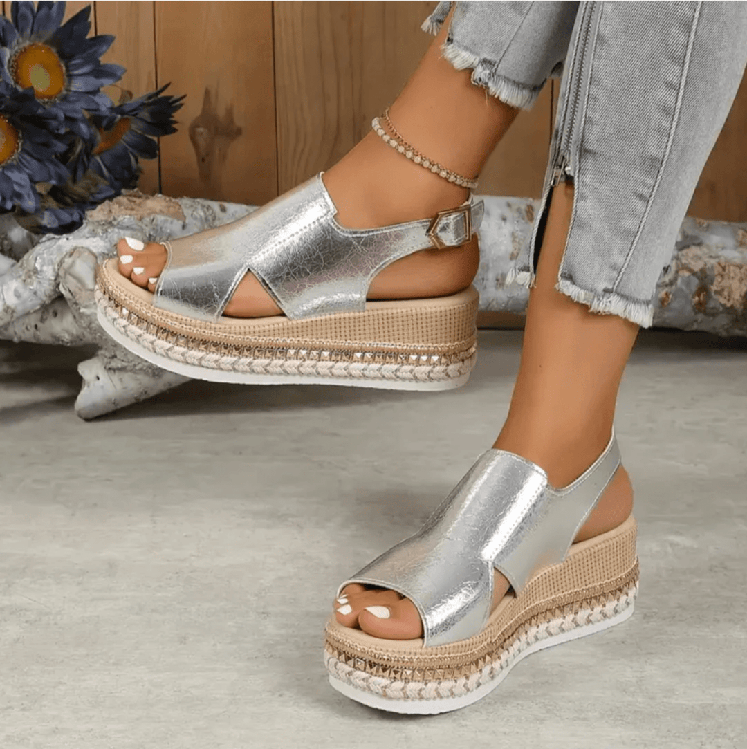 Heel-focused back angle of women’s sandal on nature background.