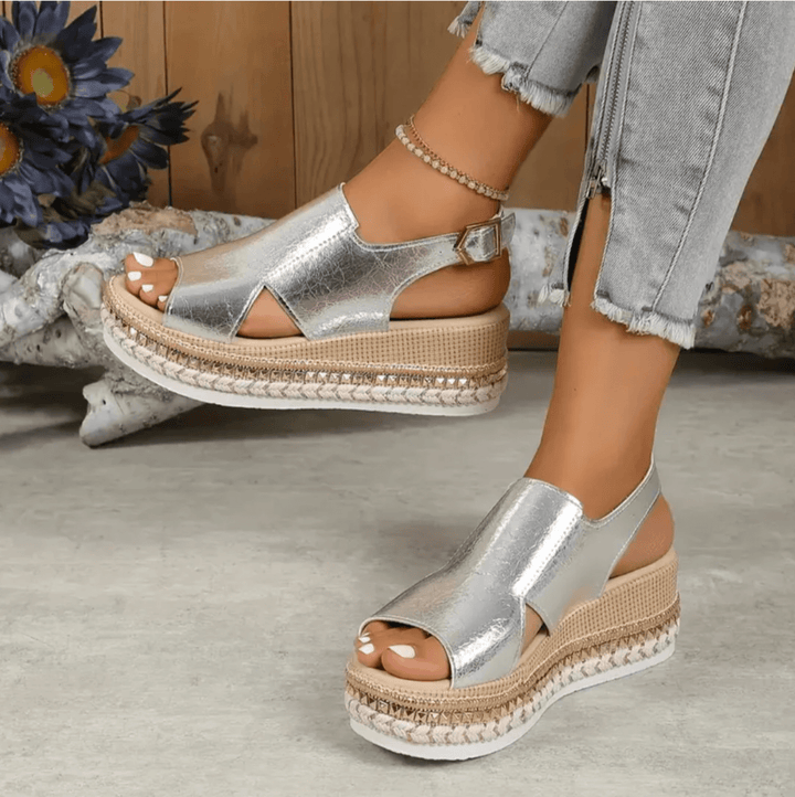 Heel-focused back angle of women’s sandal on nature background.
