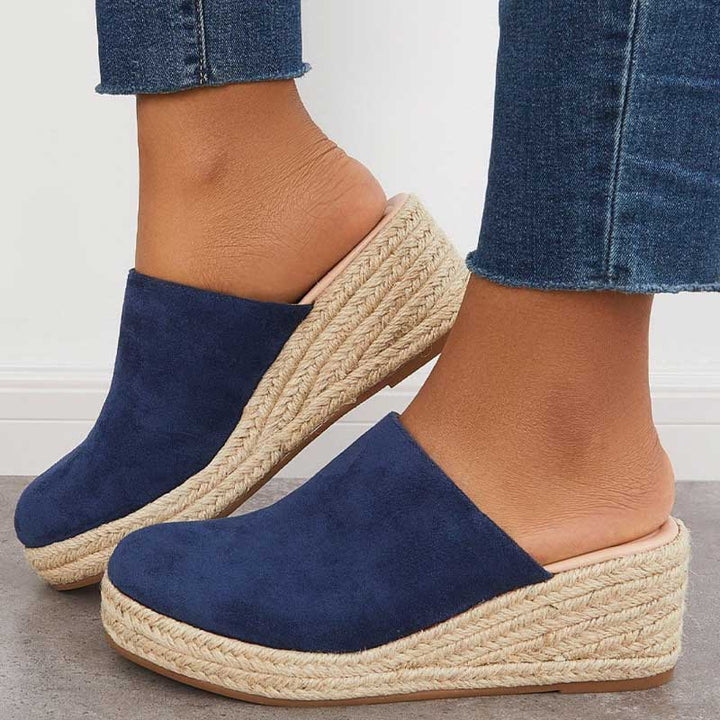 Top angle of navy espadrille mule on plain background minimal