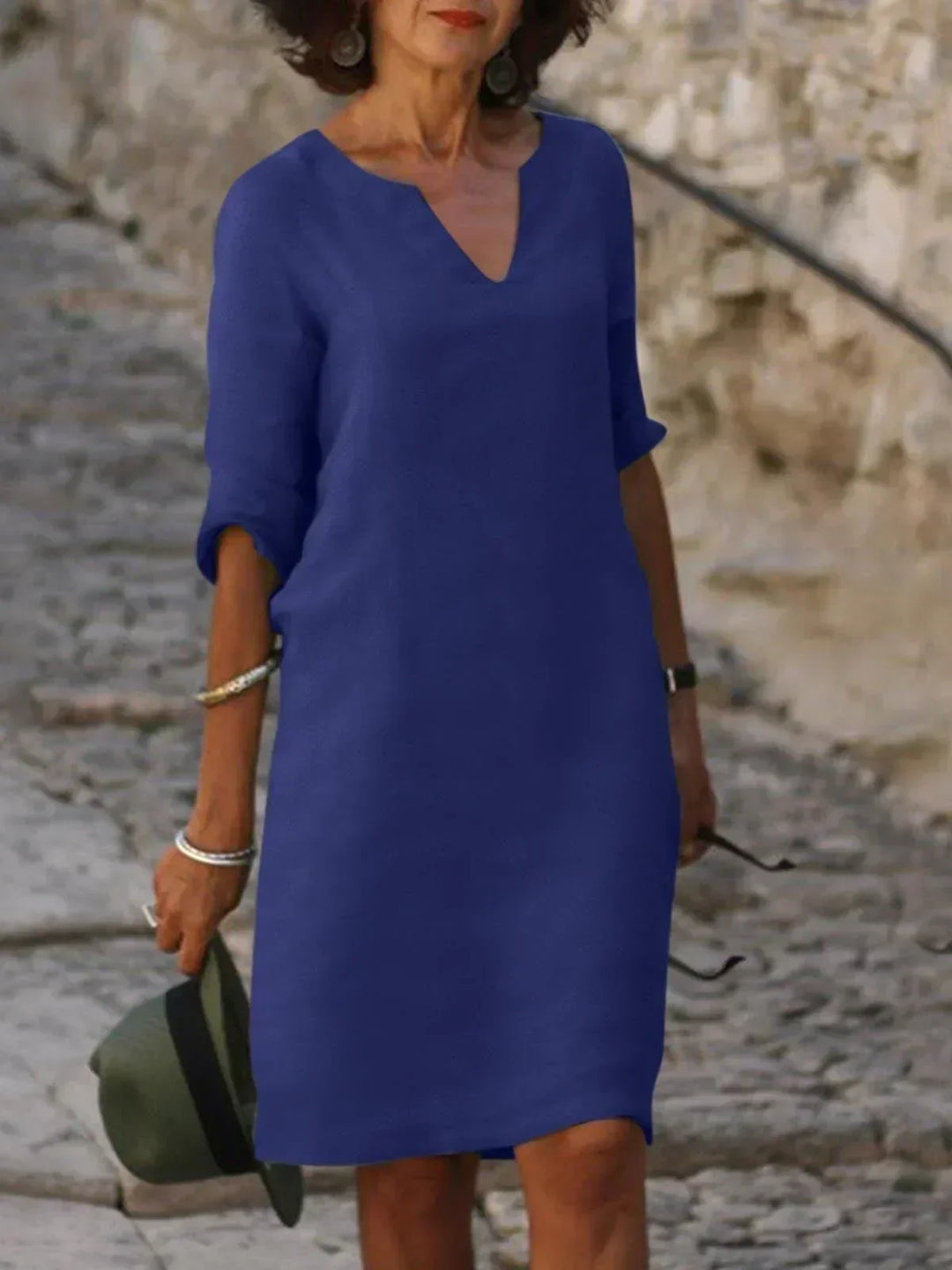 Women's blueish dress front pose on stone path.