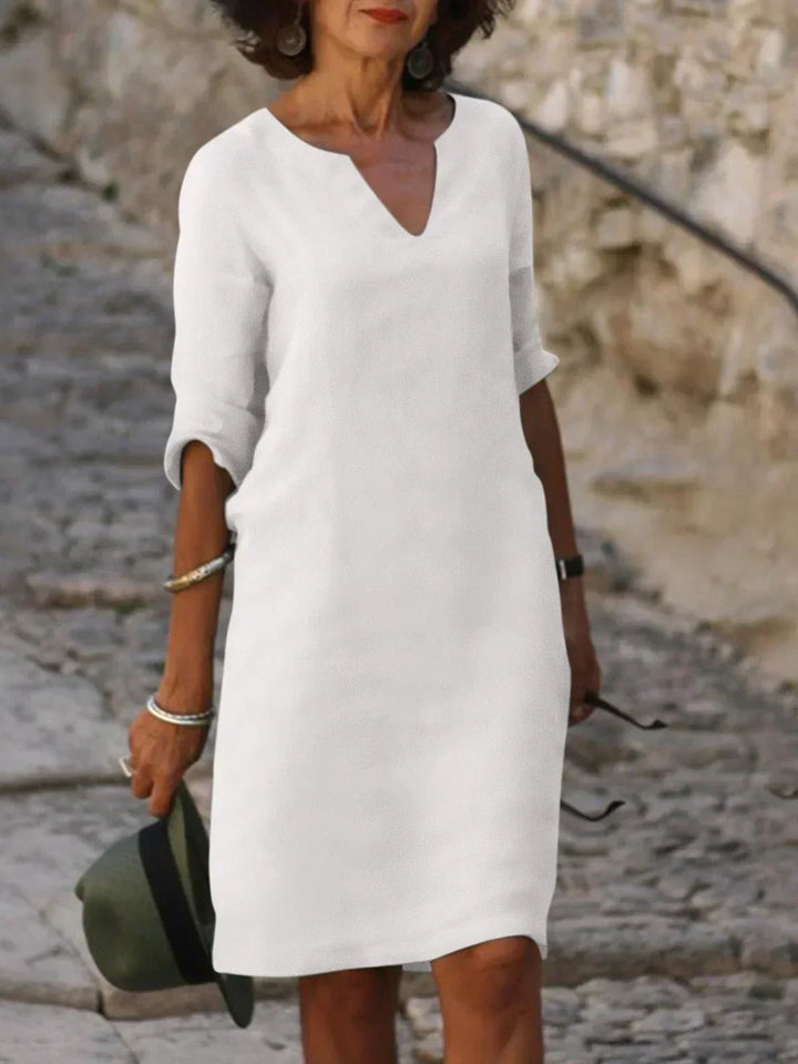 Outdoor fashion image of relaxed white dress