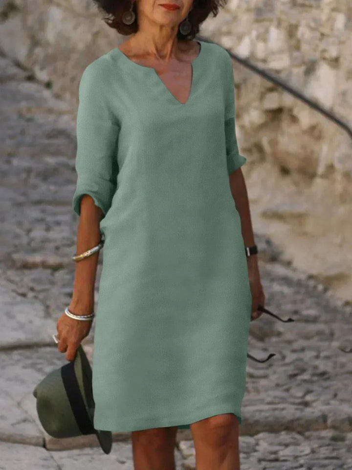 Loose green knee length dress natural outdoor backdrop