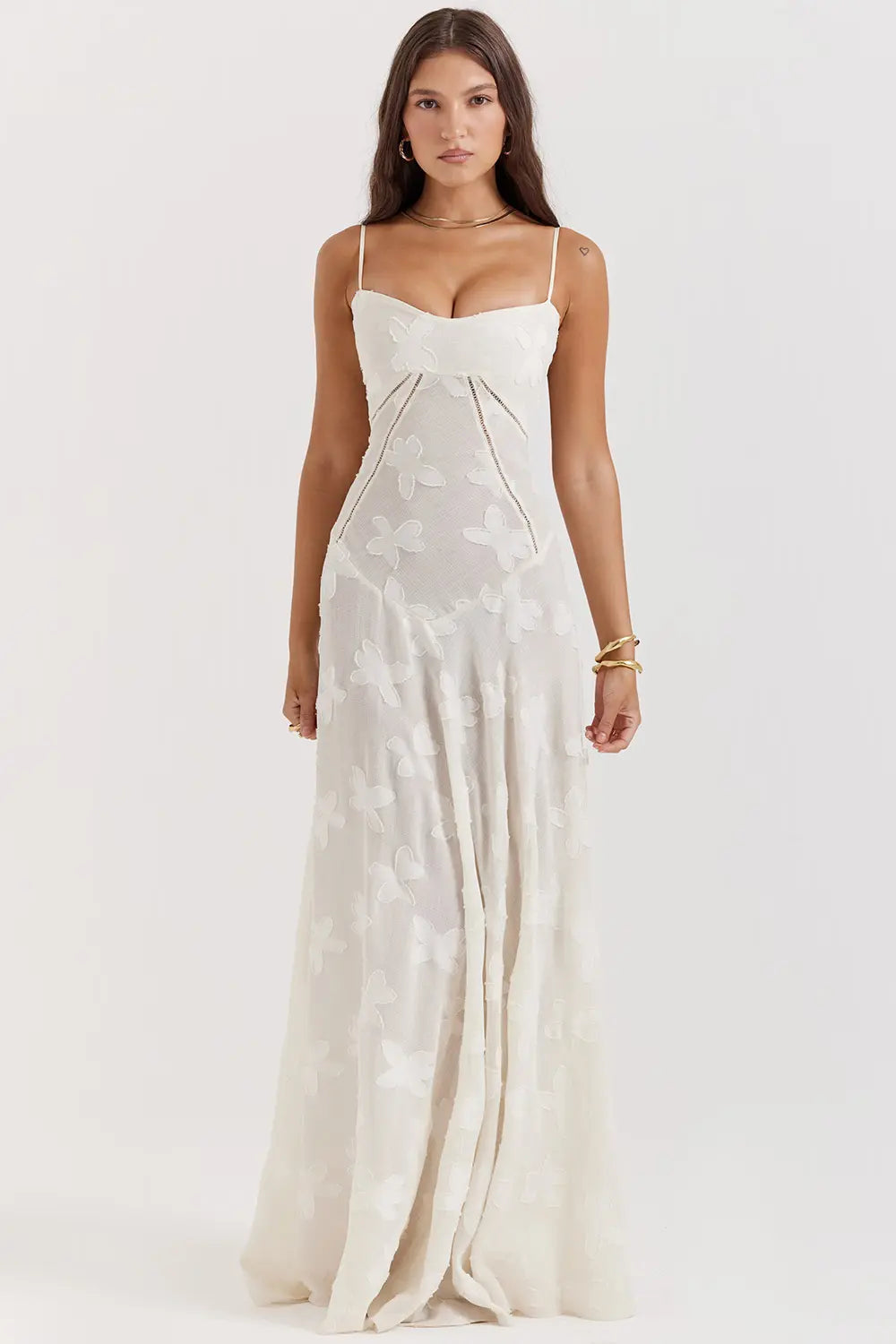 Long draped summer dress displayed on a female model with a plain backdrop.