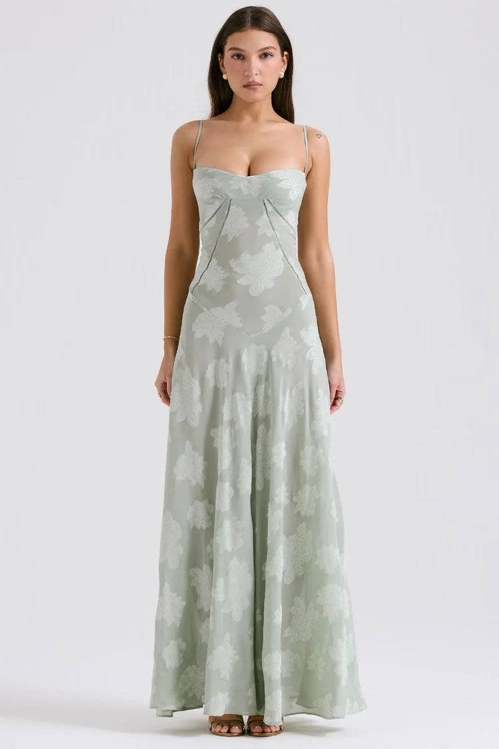 Female model showcasing a long relaxed-fit dress with an open back.