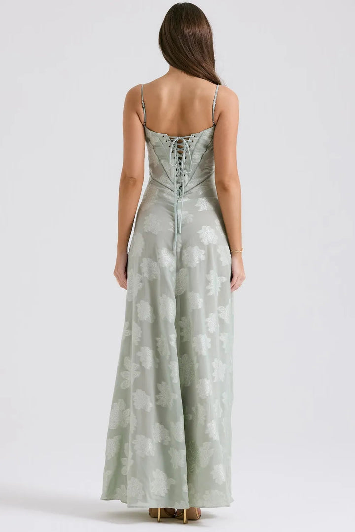 Elegant sleeveless maxi dress displayed on a woman with a plain backdrop, back view