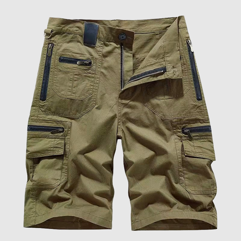  Woman showcasing structured cargo pants with secure storage pockets on a plain background.