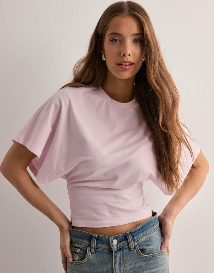 Woman wearing stylish casual top front pose clean plain background