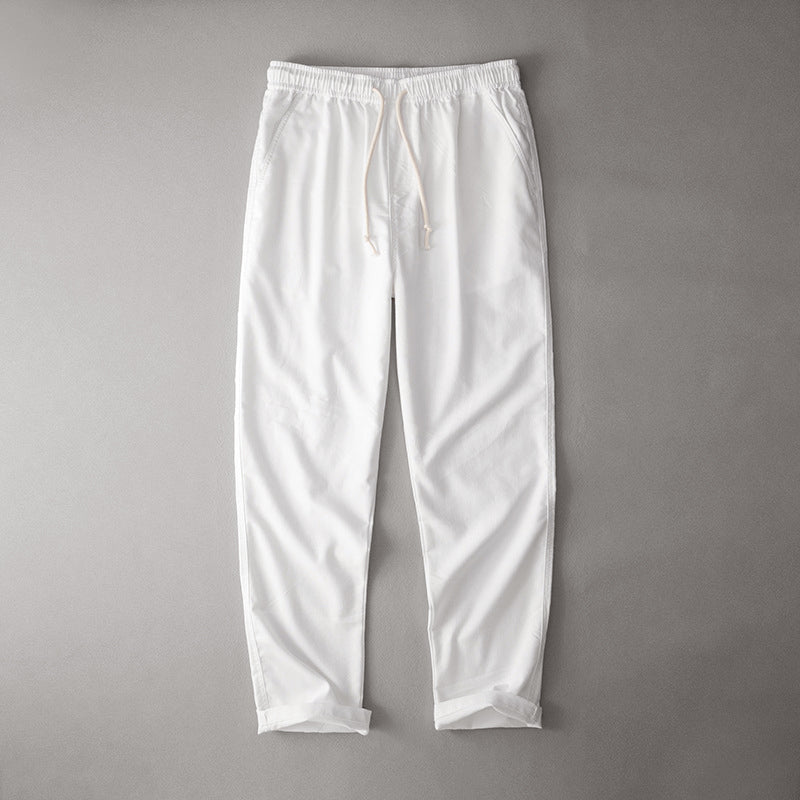 Relaxed fit drawstring pants on a plain background.