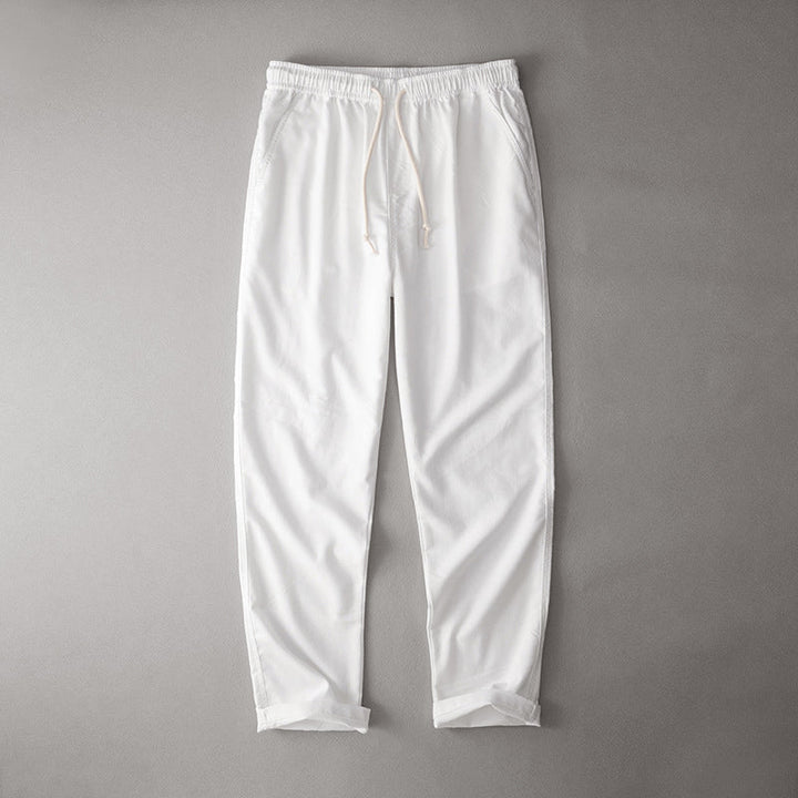 Relaxed fit drawstring pants on a plain background.
