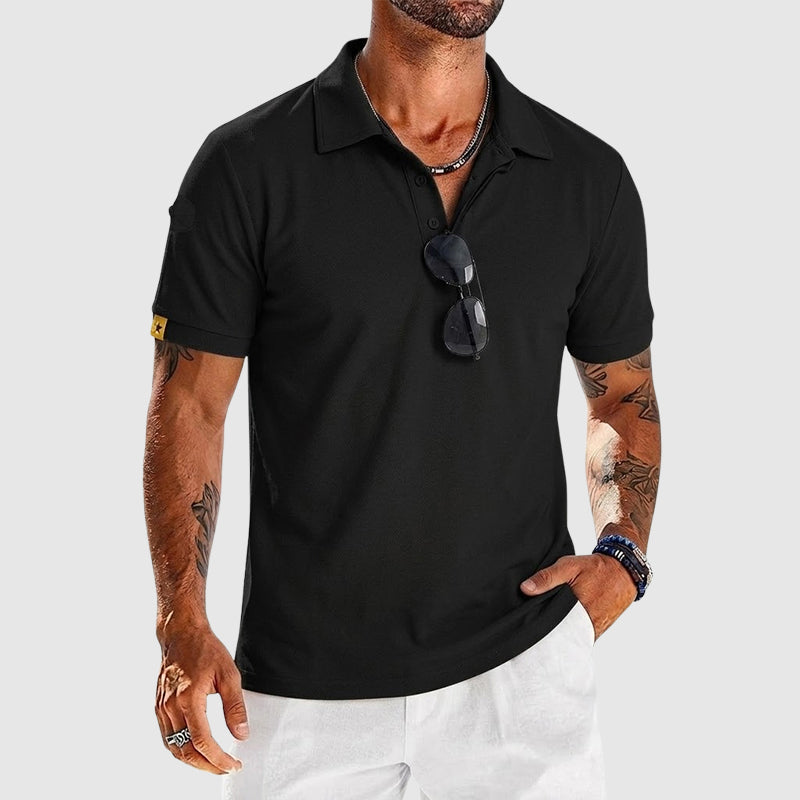  Man wearing a clean collared polo with button placket on a plain background.