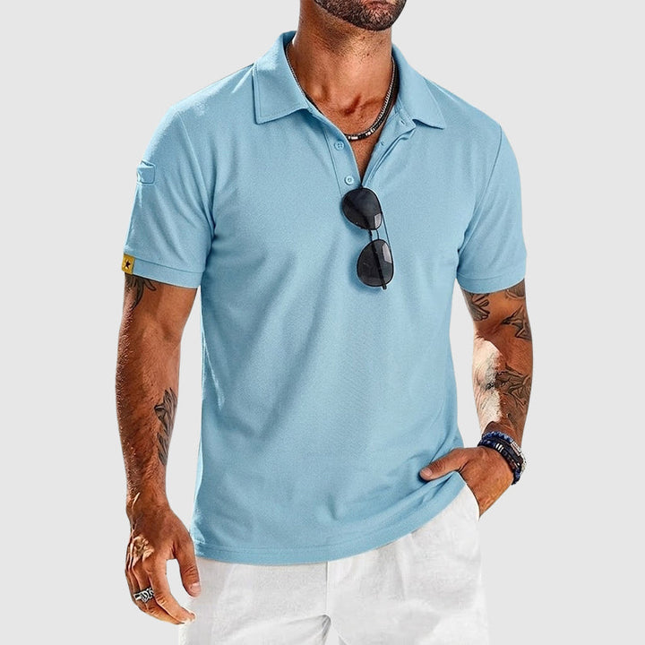  Man wearing a modern collared polo with a neat finish on a plain background.