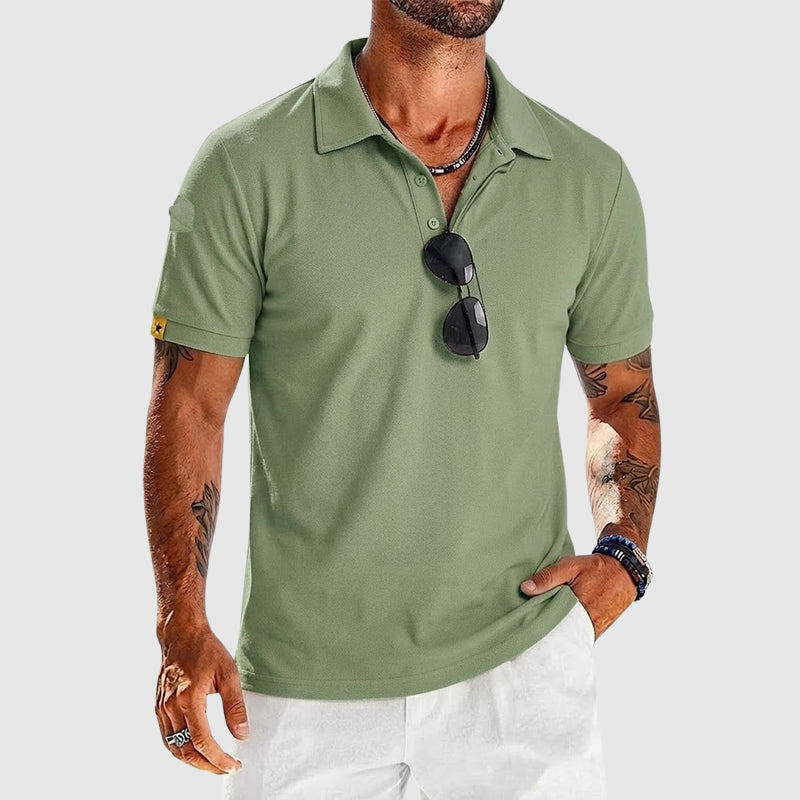  Male model wearing a button placket polo shirt on a plain background. 
