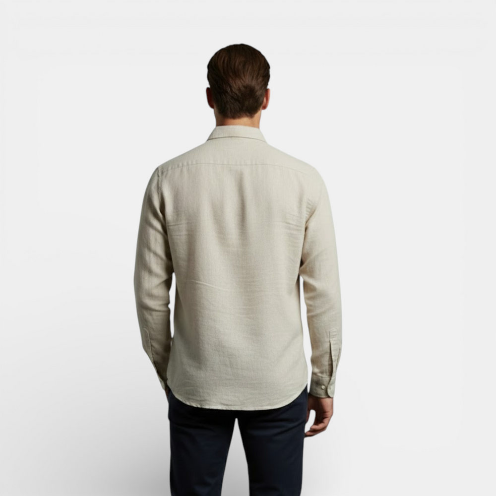  Woman modeling a relaxed long sleeve shirt with a clean summer look on a plain background.