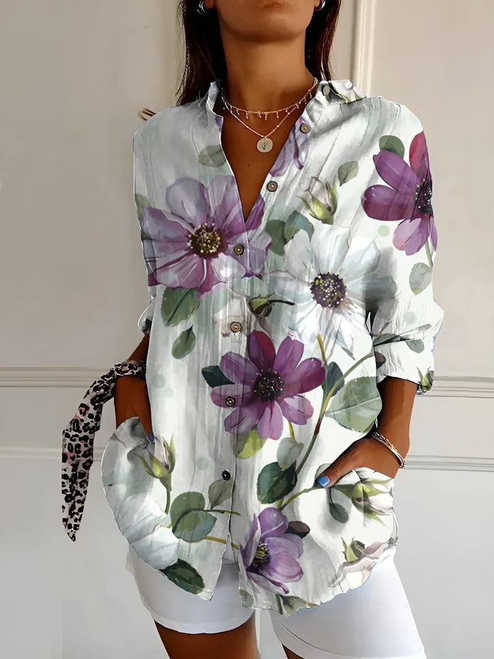 Model wearing a relaxed floral shirt with a plain background.