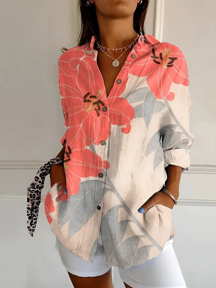 Woman model in a button-front floral blouse against a plain background.