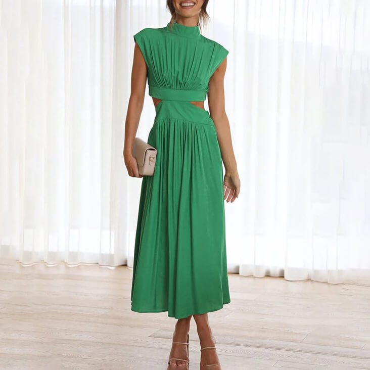 Female model wearing a floral maxi dress with a flowing fit against a plain background.