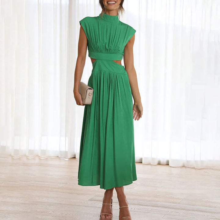 Female model wearing a floral maxi dress with a flowing fit against a plain background.