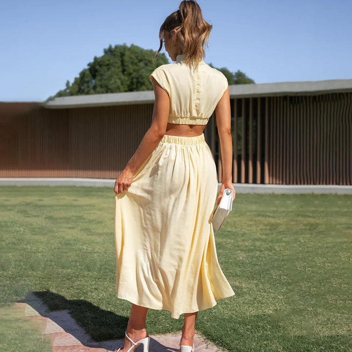Female model showcasing a floral V-neck dress with flowing movement on a plain background.