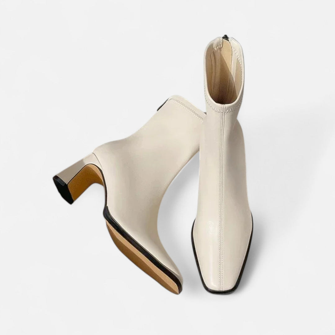 Ankle boots with a stable block heel on a plain background.