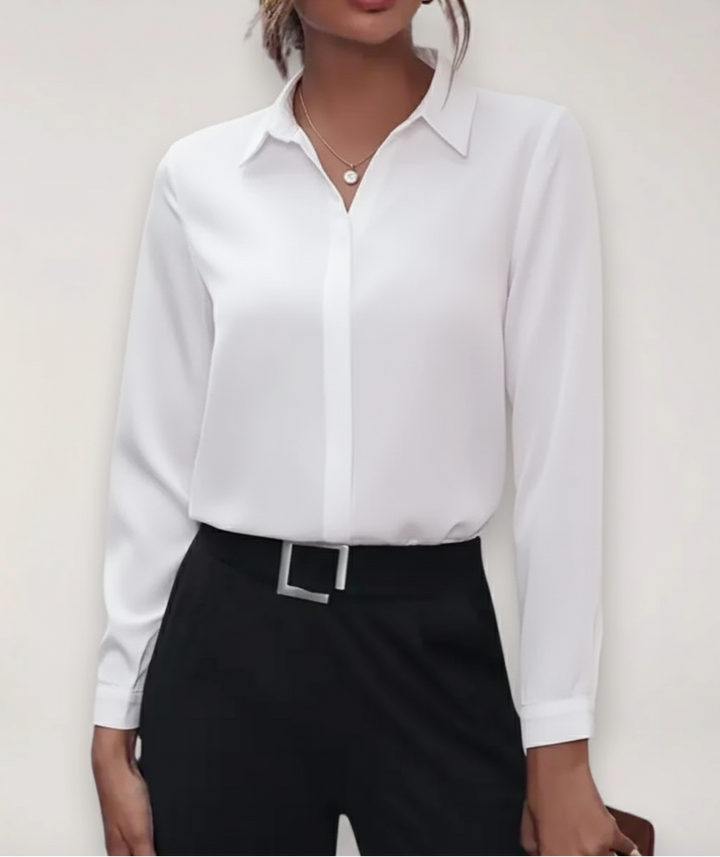 Elegant tailored button-up blouse on a clean plain background for summer office styling.