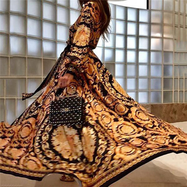 Model in a printed long sleeve maxi dress with a clean background.