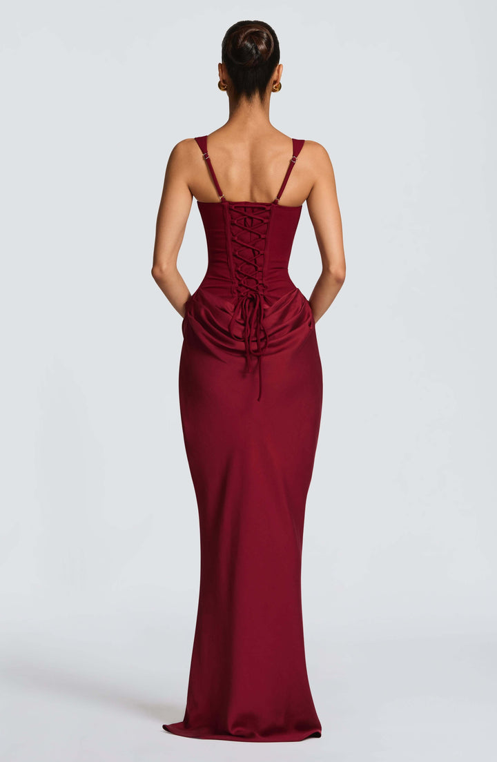 Female model styled in a bodycon maxi dress for summer events and gatherings.