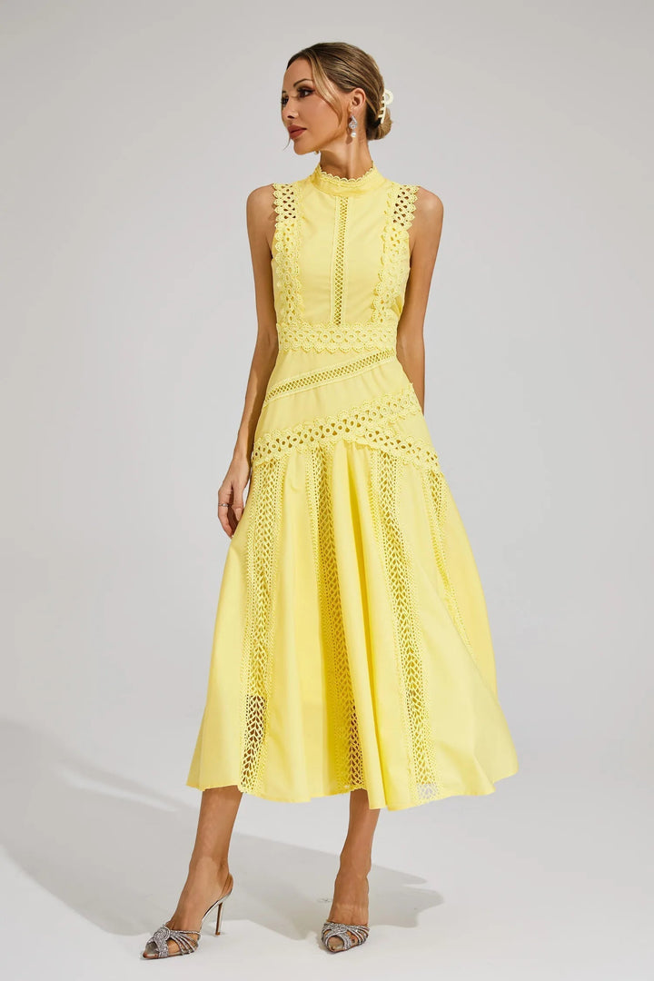 Female model showcasing a summer midi dress with intricate patterned accents.
