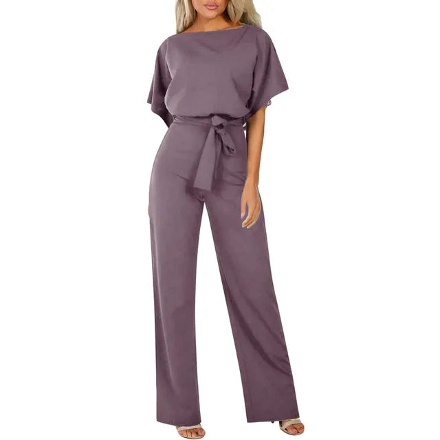 Model posing with hands down in jumpsuit plain background outfit display