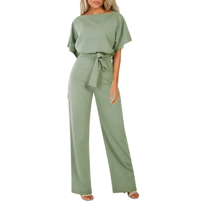 Model posing front view wearing wide leg jumpsuit plain background