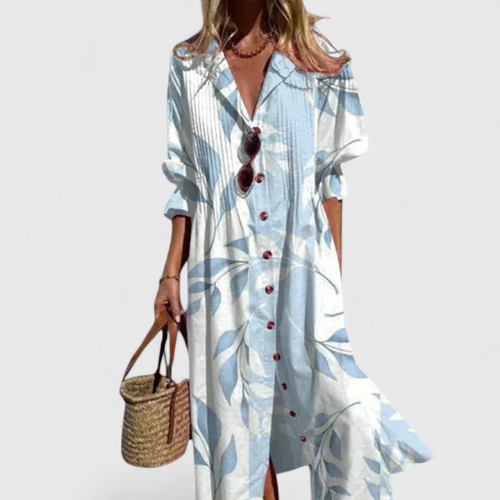 Woman model wearing a floral maxi dress with V-neck and long sleeves on a clean background.