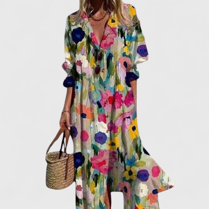 Woman model in a feminine bohemian floral maxi dress with long sleeves and V-neck.