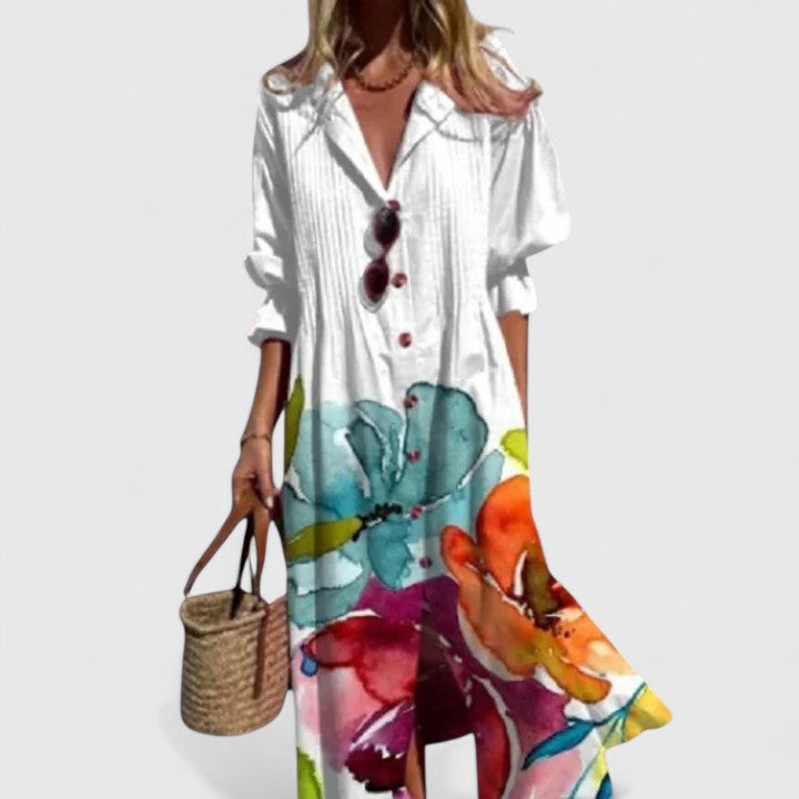 Model showcasing a button-down floral maxi dress with split front on a plain background.
