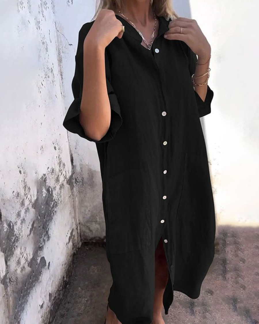 Model in a loose fit women’s shirt dress with pocket detail on a clean background.