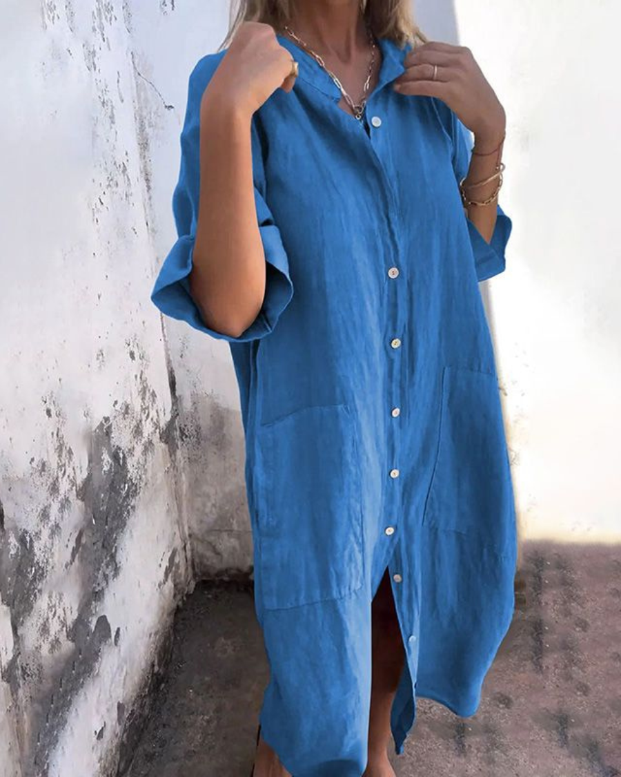 Woman showcasing a casual midi shirt dress with button-down front on a plain background.