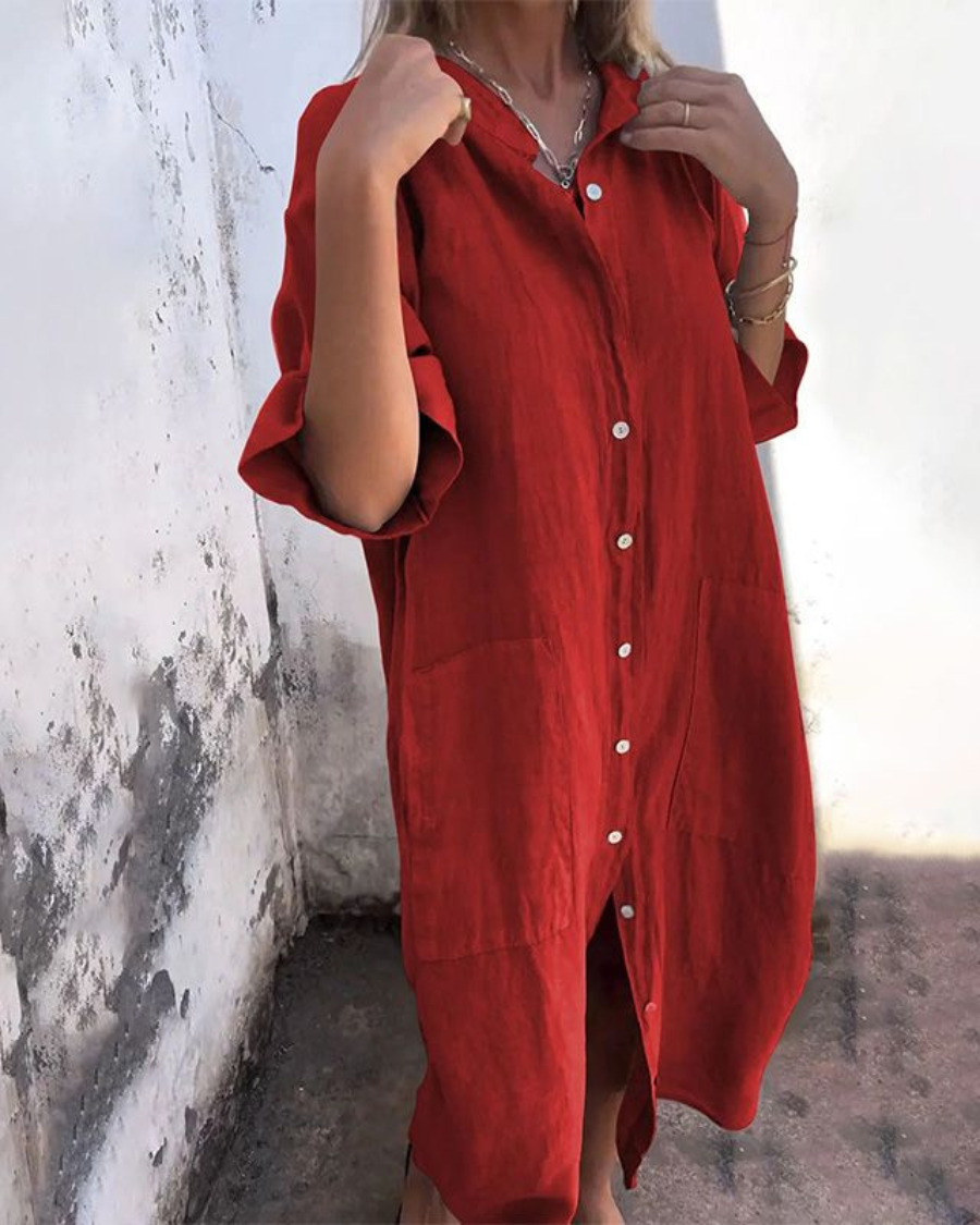 Woman model wearing a loose casual shirt dress with pockets on a clean background.