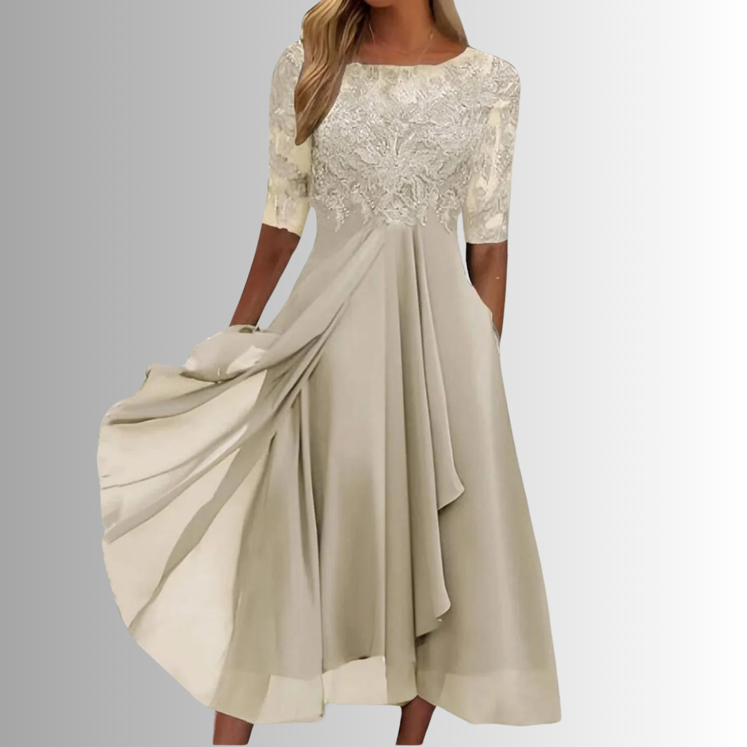 Woman model wearing a feminine midi occasion dress with lace detail and pockets.