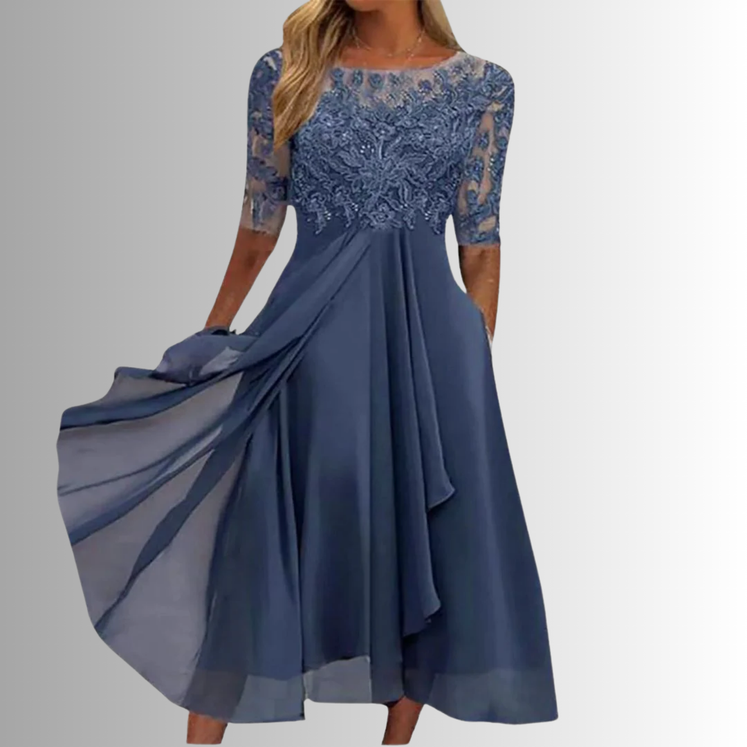 Woman model wearing an embroidered A-line midi dress with pockets on a clean background.