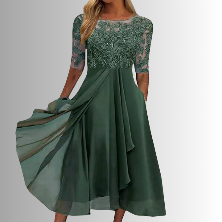 A-line embroidered midi dress with soft flowing skirt displayed on a woman model.