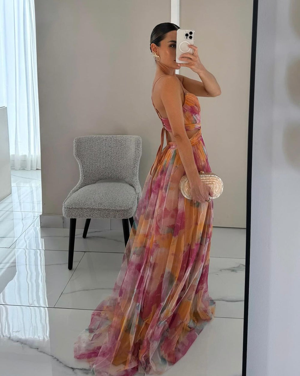 Model showcasing a summer floral maxi dress on a clean background.